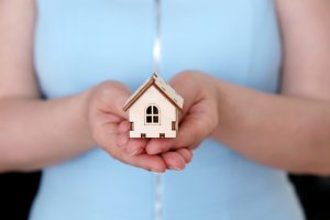 Wooden,House,In,Female,Hands,,Real,Estate,Agent.,Woman,With