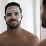 Portrait of African man with applied on face cream mask
