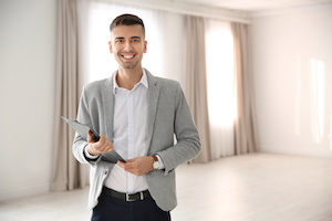 Portrait of real estate agent in empty apartment